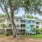 parking and large tree in front of apartment buildings at Crowne at Live Oak Square