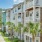 exterior shot of 4-story apartment building exterior with private balconies and patios